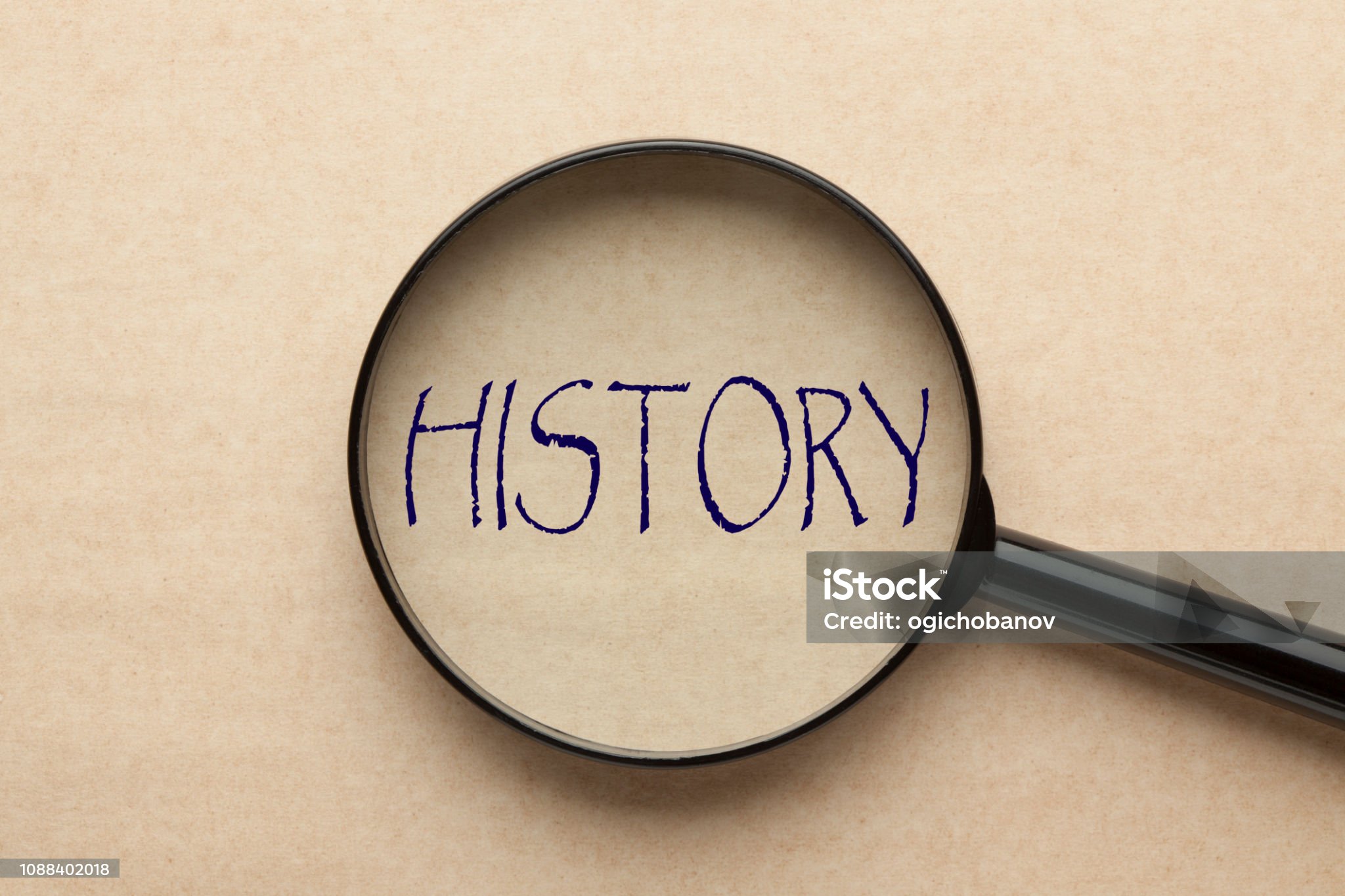 magnifying glass focusing on history word. business concept